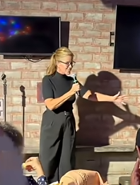 Corporate event comedian Sandra LaFlamme delivering clean stand up comedy